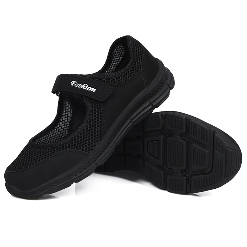 Black breathable women's vulcanized mesh sneakers with hook and loop closure, showcasing air mesh upper and flat heel for style and comfort.